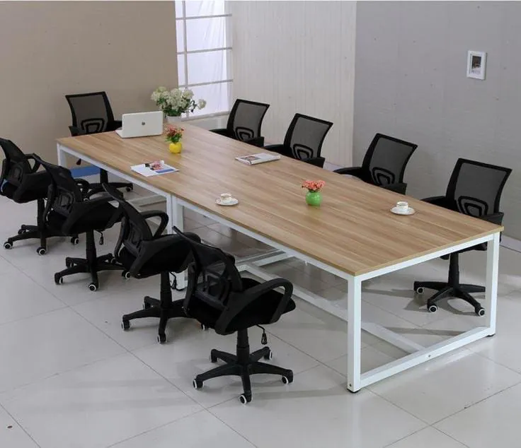 Long conference table with black mesh chairs